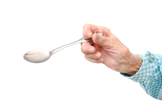 The hand of a 95-year-old elderly woman holds a spoon, isolated on a white background.Rheumatoid polyarthritis of the hands of a 95-year-old woman.
