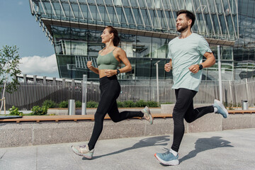 Fitness couple jogging together in an urban environment.