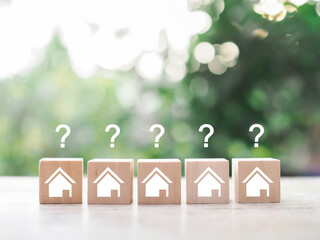 Miniature house with question mark icons.The concept of choosing suitable house for planning living...