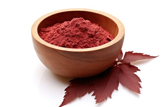 Close up of dried ground red Sumac powder spices in a wooden bowl isolated on a white background