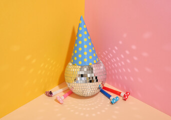 Birthday party preparations. Bright emotions and disco ball. Hat and party whistle blowers.