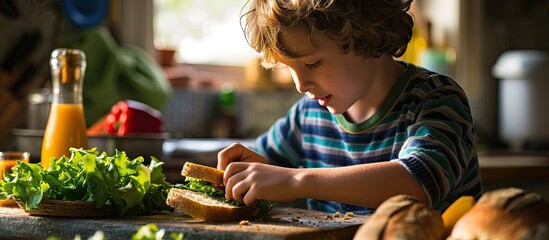 Cute little boy making vegetable sandwich with fresh ingredients he places lettuce on bread in kitchen at home. Creative Banner. Copyspace image - Powered by Adobe