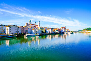Fototapeta premium View of some buildings and the surrounding landscape by the river in the city of Passau. 
