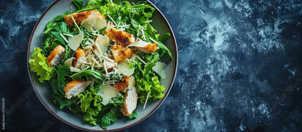 Poster caesar salad with chicken romaine and parmesan shot from the top. creative banner. copyspace image
