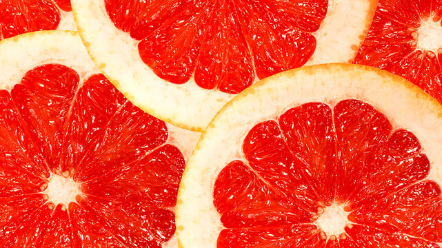 Background of grapefruit slices close-up. Top view. Macrography.