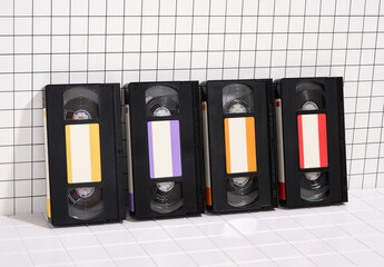 The videotapes stand in a row. Old video equipment from the 80s, 90s. - obrazy, fototapety, plakaty