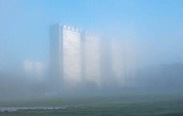 Multi-storey residential buildings in a residential area during the morning fog