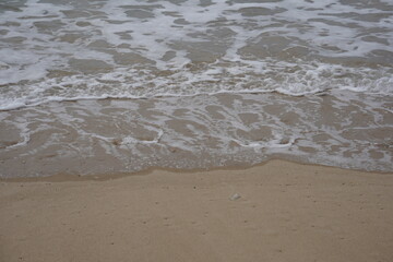 Mediterranean sea waves crushing on a sandy beach
