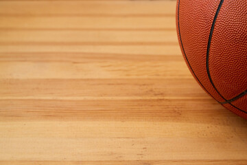 Basketball ball close-up on a wooden floor. Sports background, basketball background