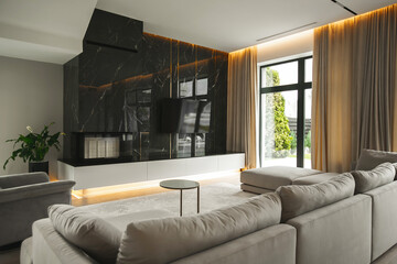 Elegant and comfortable designed cream living room with marble big sofa and big windows