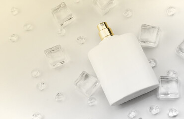Female perfume mat white bottle, objective photograph of perfume bottle in ice cubes and water on...