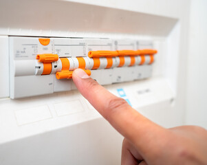 Close-up of man turning off the fusebox