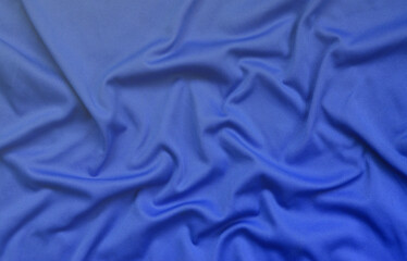 Detailed polyester blue fabric texture with many long folds