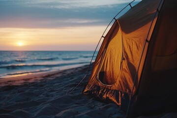 Sunset Serenity: Experience the Tranquility of Coastal Camping with a Tent Posing Silhouetted Against the Sandy Beach, Illuminated by the Soft Golden Hues of the Setting Sun.

