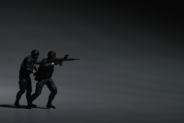 A low light picture of anti terrorist and copyspace dark background. Fighting crime concept. - obrazy, fototapety, plakaty