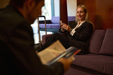 Man and woman sitting at hotel lobby
