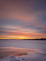 Fototapeta na wymiar Wonderful winter sunset above the frozen lake, vertical background