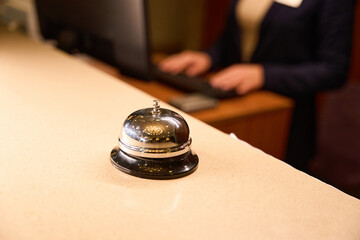 Close up photo of metal reception bell standing on desk