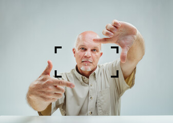 Man frames space, envisioning with pointed precision