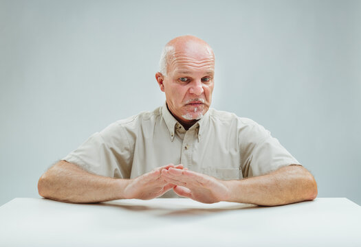 Man disturbed, crossed hands signal deep displeasure