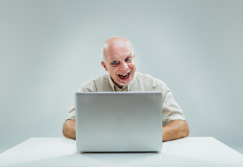 Man's laptop discovery prompts excited, tempted smile