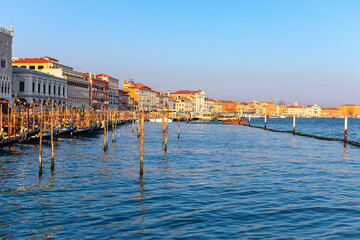 View of water canal and moored gondolas in Venezia . Grand Canal major tourist attraction in Venice.