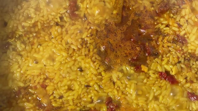Surface of pilaf during preparation in a pot, top view