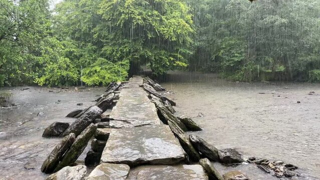 Torrential rain on the River Berle, at Tarr Steps, near Dulverton, Devon, England