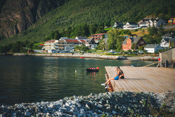 Wooden pier in a Norwegian village on the shore of a fjord. Summer in Norway concept