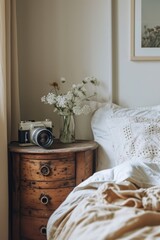 Retro Charm: Vintage Camera Resting on Round Wooden Nightstand in Cozy Bedroom Setting