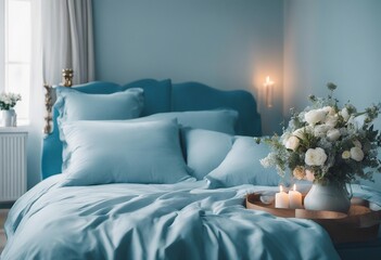 Cozy light blue Bedroom with flowers and candles pillows duvet and duvet case on a bed Blue bed line