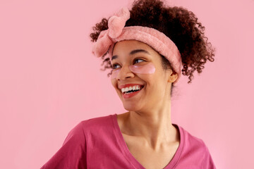Smiling attractive mixed race girl with clean skin and pink patches under her eyes