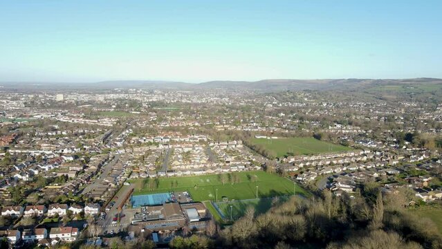 Aerial drone video flying towards Cheltenham, England, UK, from Leckhampton Hill looking north. View over the town.