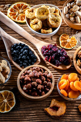 Composition with a variety of dried fruits and assorted nuts.