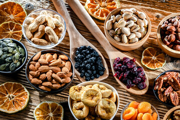 Composition with a variety of dried fruits and assorted nuts.