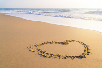 drawing a heart shape on the sand in the morning. love and emotions To welcome the Valentine's Day festival