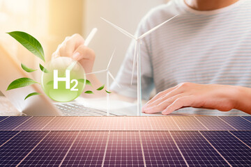 Teenage boys use laptops to analyze Green Nature H2 hydrogen innovation zero-emissions technology...