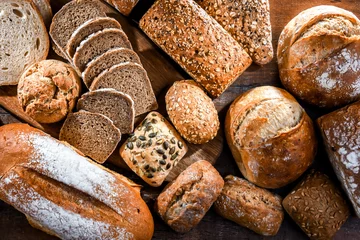 Fotobehang Assorted bakery products including loaves of bread and rolls © monticellllo