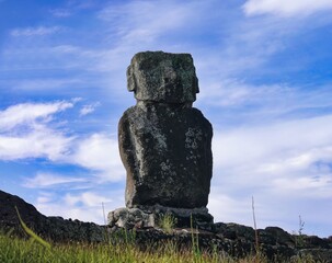 A beautiful Moai Statue, perfectly preserved, immersed in the wild and mysterious landscape of...