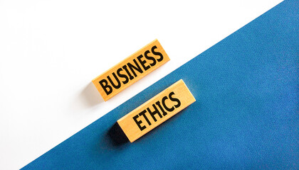 Business ethics symbol. Concept words Business ethics on beautiful wooden blocks. Beautiful white and blue background. Business ethics concept. Copy space.