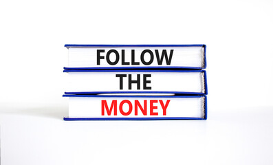Follow the money symbol. Concept words Follow the money on beautiful books. Beautiful white table white background. Business and follow the money concept. Copy space.