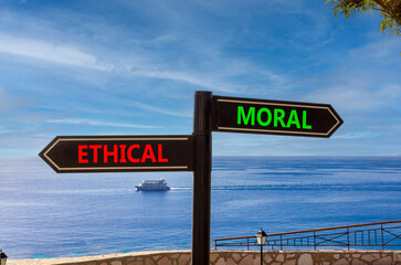 Ethical or moral symbol. Concept word Ethical or Moral on beautiful signpost with two arrows....