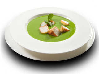 Crema de berros con pollo sobre fondo blanco. Watercress cream with chicken on a white background.