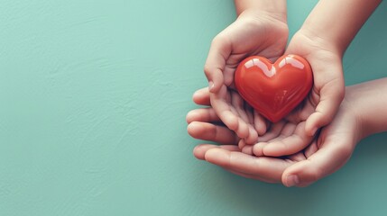 adult and child hands holding red heart on aqua background, heart health, donation, CSR concept, world heart day, world health day, family day  - obrazy, fototapety, plakaty