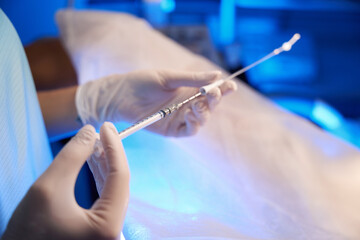 Close up of doctor hands using syringe for artificial fertilization