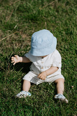 Baby boy in grass, top view, vertical frame