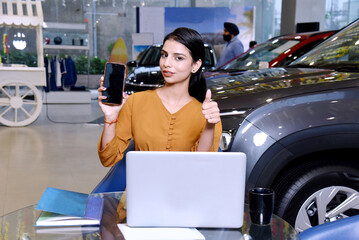 Young indian woman showing smart phone screen
