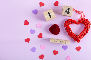 Valentine's Day background. Decorations heart shaped confetti, gift boxes in wrapping paper