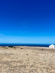 White temple at the ocean coast, ocean blue horizon