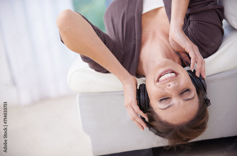 Canvas Prints Woman, smile while upside down on sofa and headphones for music, audio streaming and stress relief for fun at home. Podcast, listen to radio and subscription online, relax in living room with tech